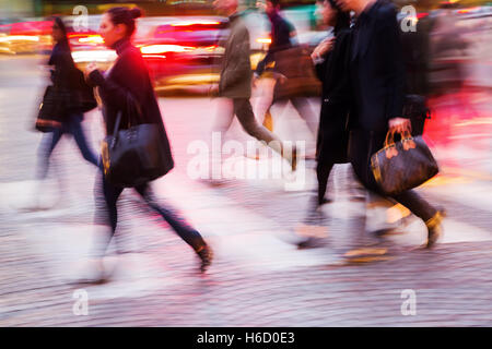 picture in motion blur of people crossing a city street at night Stock Photo