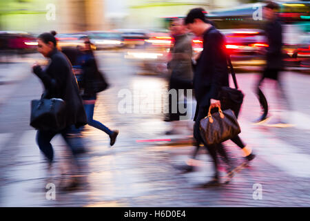 picture in motion blur of people crossing a city street at night Stock Photo