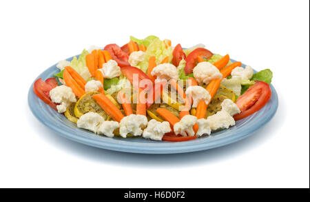 Colorful mixed vegetables with sauteed squash on a light blue plate, on white Stock Photo