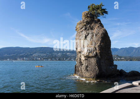 Vancouver, Canada: Landmark Siwash Rock in Stanley Park. In the distance is West Vancouver. Stock Photo