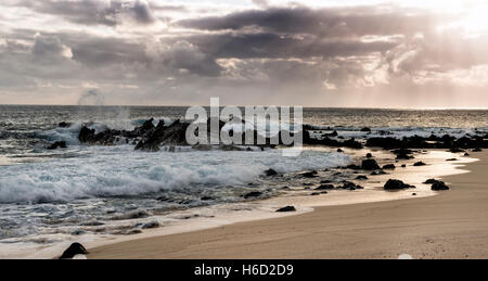 Ascension Island Rocks at Dead Man's Beach Georgetown at sunset with dark clouds at sea Stock Photo