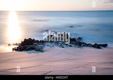 Ascension Island Rocks at Dead Man's Beach Georgetown at sunset artistic long exposure Stock Photo