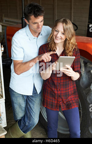 Male And Female Agricultural Workers Looking At Digital Tablet Stock Photo