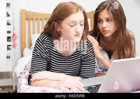 Teenage Girl With Friend Being Bullied On Line Stock Photo