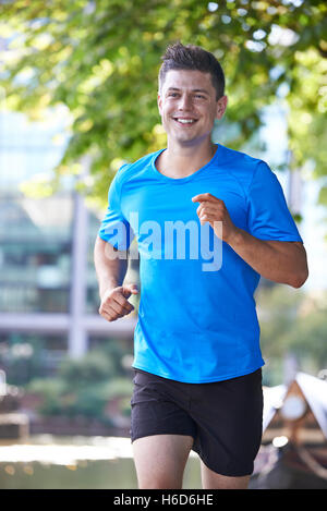 Young Man Running In Urban Setting Stock Photo