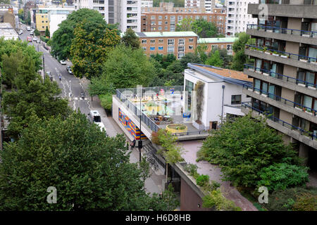 A view of the colourful Prior Weston Primary School Golden Lane Estate Campus  next to Barbican flats in Islington London England UK  KATHY DEWITT Stock Photo