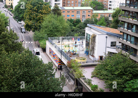 A view of the colourful Prior Weston Primary School Golden Lane Estate Campus  next to Barbican flats in the City of London England UK  KATHY DEWITT Stock Photo