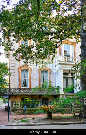 The faded grandeur of the old Noble Hardee Italianate style mansion is filled with Alex Raskin antiques in downtown Savannah, GA Stock Photo