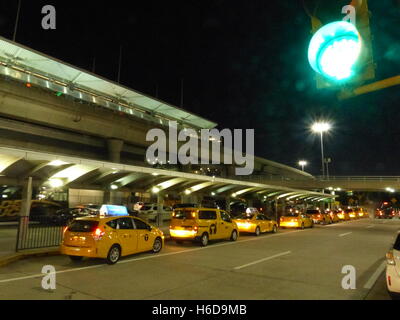 Yellow cabs waiting for passenger at British Airways Terminal at John Fitzgerald Kennedy International Airport Stock Photo