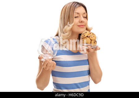 Woman smelling cookies in a jar isolated on white background Stock Photo