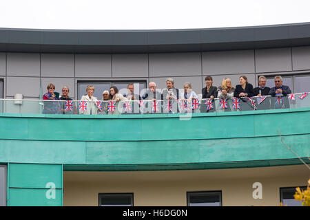 Dorchester, Dorset, UK. 27 October 2016. Royal supporters wait on balcony overlooking Dorchester South train station for the arrival of the Royal Party on the Royal train (Her Majesty the Queen accompanied by Prince Philip, Charles Prince of Wales and Camilla Duchess of Cornwall) before they go on to Poundbury Credit:  Carolyn Jenkins/Alamy Live News Stock Photo