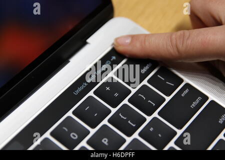 Cupertino, USA. 27th Oct, 2016. The fingerprint sensor on a new MacBook Pro in Cupertino, USA, 27 October 2016. Apple presented a series of models of its notebooks: On the MacBook Pro model, the row of control keys will be replaced with a thin touch-screen bar. Various buttons and control elements suited to the app will be displayed there. In addition, a fingerprint sensor will be integrated into the 'TouchBar, ' which will enable users to log onto their computer with a fingerprint. This will also allow the iPhone paying service Apple Pay to be used directly on the computer for online purchase Stock Photo