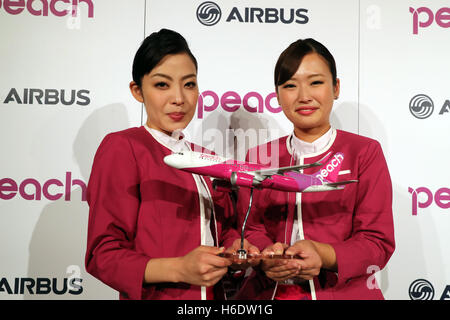 Tokyo, Japan. 18th Nov, 2016. Cabin attendants of Japan's budget airline Peach Aviation display a scale model of Airbus A320 as Peach will buy 13 aircrafts of Airbus A320 at a press conference in Tokyo on Friday, November 18, 2016. Peach will purchase 3 A320 ceo aircrafts in 2018 and will receive the first A320 neo in 2019 from the Airbus. © Yoshio Tsunoda/AFLO/Alamy Live News