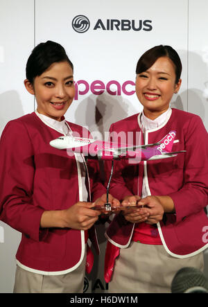 Tokyo, Japan. 18th Nov, 2016. Cabin attendants of Japan's budget airline Peach Aviation display a scale model of Airbus A320 as Peach will buy 13 aircrafts of Airbus A320 at a press conference in Tokyo on Friday, November 18, 2016. Peach will purchase 3 A320 ceo aircrafts in 2018 and will receive the first A320 neo in 2019 from the Airbus. © Yoshio Tsunoda/AFLO/Alamy Live News