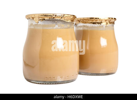Milk dessert in jars. Isolated with clipping path. Stock Photo