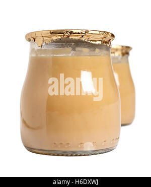 Milk dessert in jars. Isolated with clipping path. Stock Photo