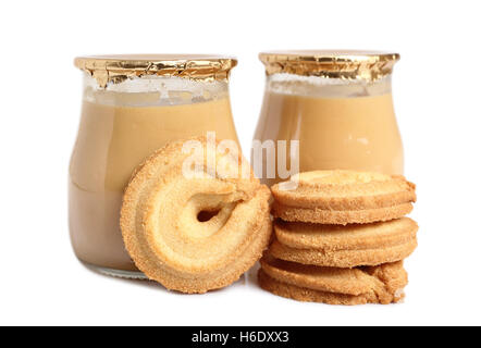Milk pudding in bottles and cookies. Isolated on a white background. Stock Photo
