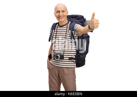Joyful elderly hiker giving a thumb up isolated on white background
