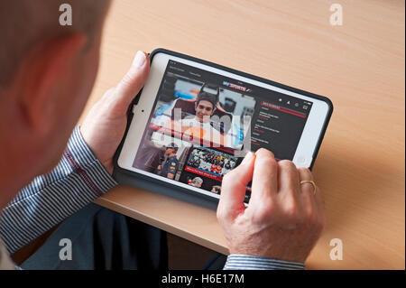 Close up of person man looking at watching Sky Sports app on ipad tablet screen England UK United Kingdom GB Great Britain Stock Photo