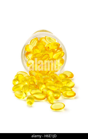 Capsule of medicine spill out of a glass bottle on white background Stock Photo
