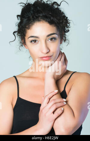 Beautiful young woman hand touching neck Stock Photo