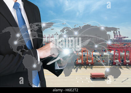 Businessman press digital tablet to show global network partnership connection use for logistics,import,export background Stock Photo