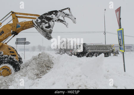 Bucharest, Romania, 17 January 2016: A road sweeping vehicle clears snow from the highway A2, the main commercial route which co Stock Photo