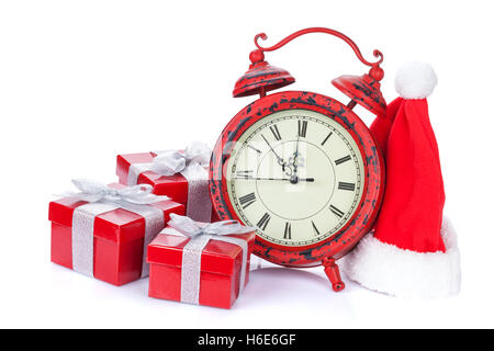 Christmas clock, gift boxes and santa hat. Isolated on white background Stock Photo