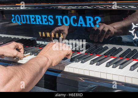 Male pianist performing outdoors in a plaza during the Madrid full of pianos day at 8 public locations in Madrid. Stock Photo
