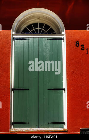 Green Door or Shutters on a Red Building in the French Quarter of New Orleans Stock Photo