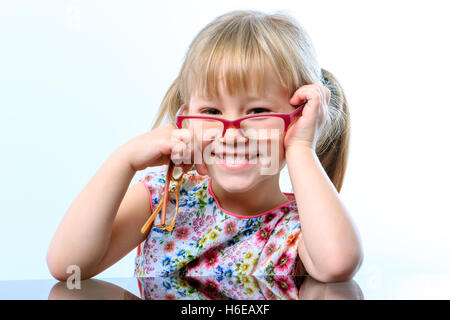 Close up portrait of Funny little girl wearing eye wear on nose. Stock Photo