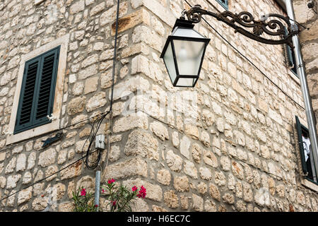 A wrought Iron street lamp on an old stone building at Ston Croatia Stock Photo