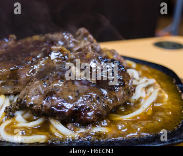 Steak with pasta in metal plare Stock Photo