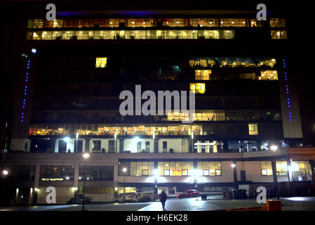 individual man walking away from illuminated  skypark  finnieston glasgow office tower block at night Stock Photo