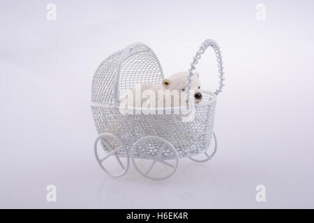 Little  Polar bear figure in a toy  baby carriage  made of metal on Stock Photo