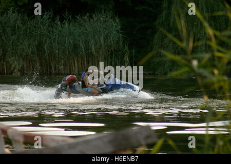 People riding water scooter (jet-ski) on lake Stock Photo