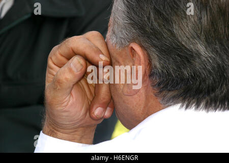 Detail of hard working hand near a man's face Stock Photo