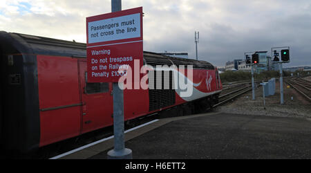 Virgin East Coast Mainline Train,Aberdeen Railway Station,Scotland,UK - Passengers must not cross the line sign Stock Photo