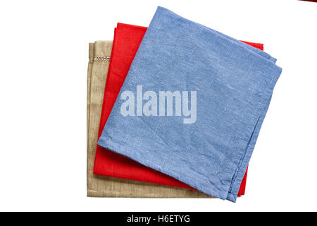 Three colored fabric napkins, blue, red and beige, un white Stock Photo