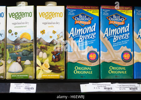 Packages of almond milk and veggemo beverages showing price in dollars Stock Photo