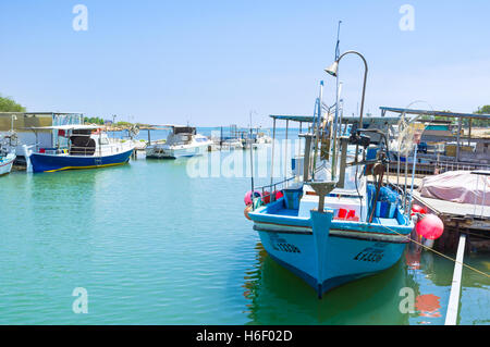 The boats moored on the river banks in small fishing village, Liopetri. Stock Photo