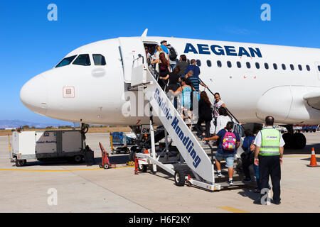Passengers boarding a commercial jet plane at Rhodes Diagoras international airport.