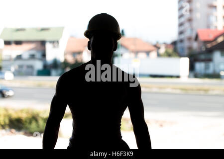 Silhouette Man Construction Worker On Construction Site Stock Photo