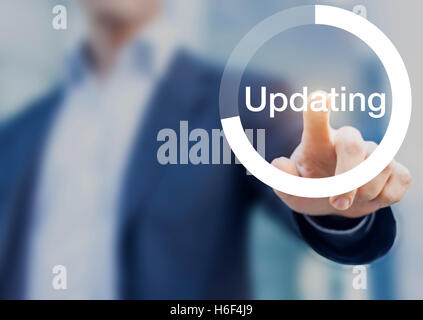 Concept about software updating with a person touching a progress button on a computer interface Stock Photo