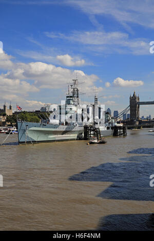 HMS Belfast, the museum ship, moored on the River Thames, with Tower Bridge behind, in London, England, UK