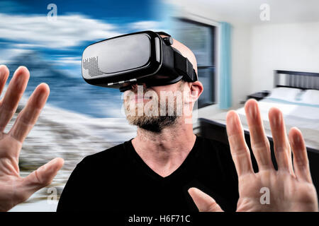 Man wearing VR headset and touching something with his hands (montage) Stock Photo