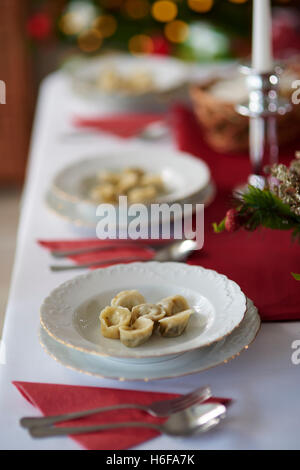 Many plates on Christmas table Stock Photo