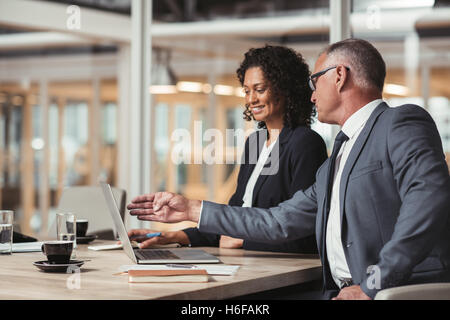 Discussing work with his young staff Stock Photo
