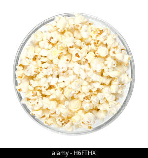 Popped popcorn in glass bowl on white background. Butterfly shaped popcorn puffed up from the kernels, after it has been heated. Stock Photo