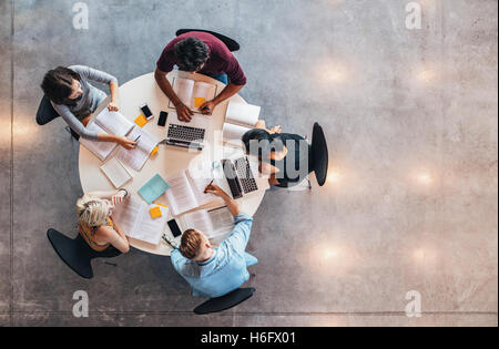 Top view of group of students sitting together at table. university students doing group study. Stock Photo